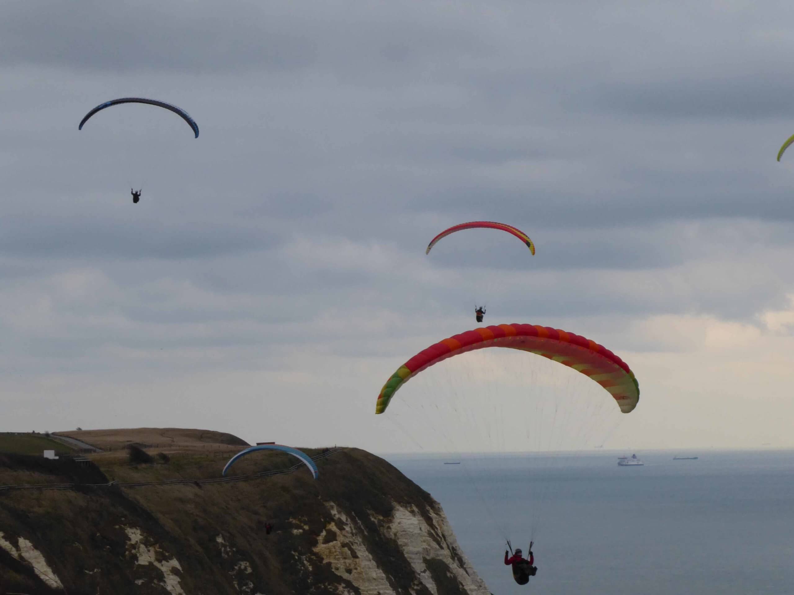 A group of people paragliding